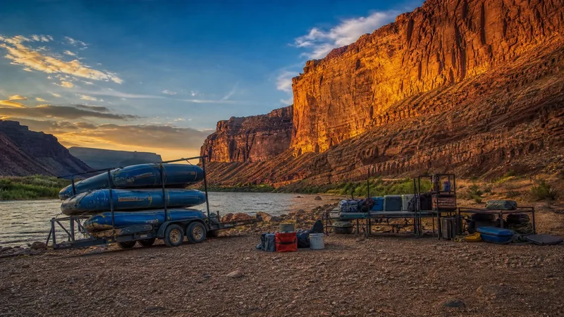 Adventure outfitter staging area with a raft trailer and red rock canyon walls, Moab Business License